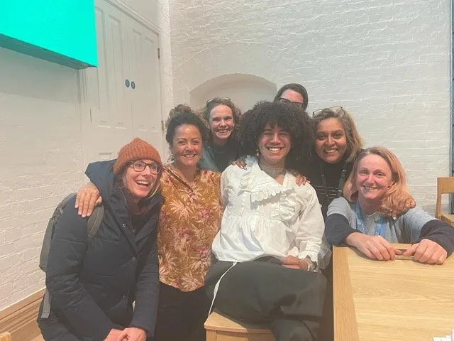 Helen Wilson Roe smiling with a group of students and staff at the University of Oxford