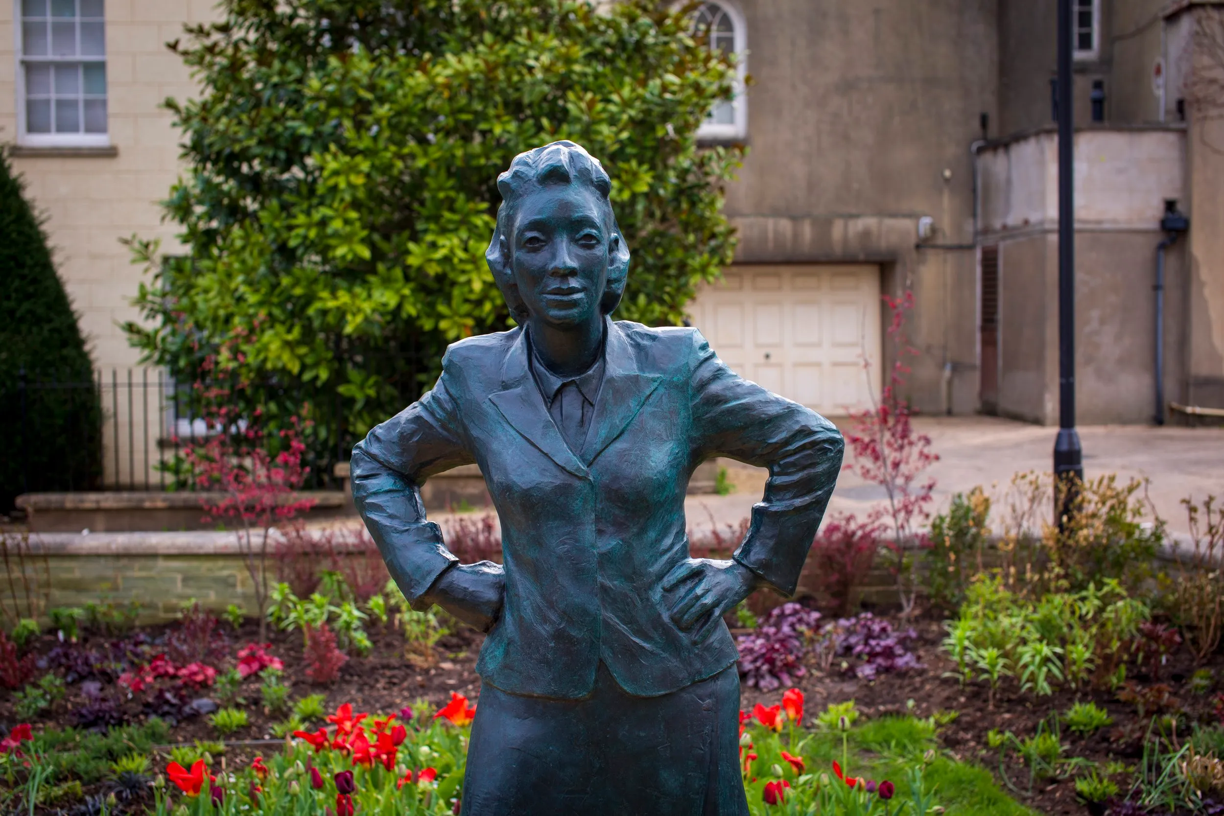 Three-quarter view of the bronze statue of Henrietta Lacks, hands on hips, sculpted by Helen Wilson Roe