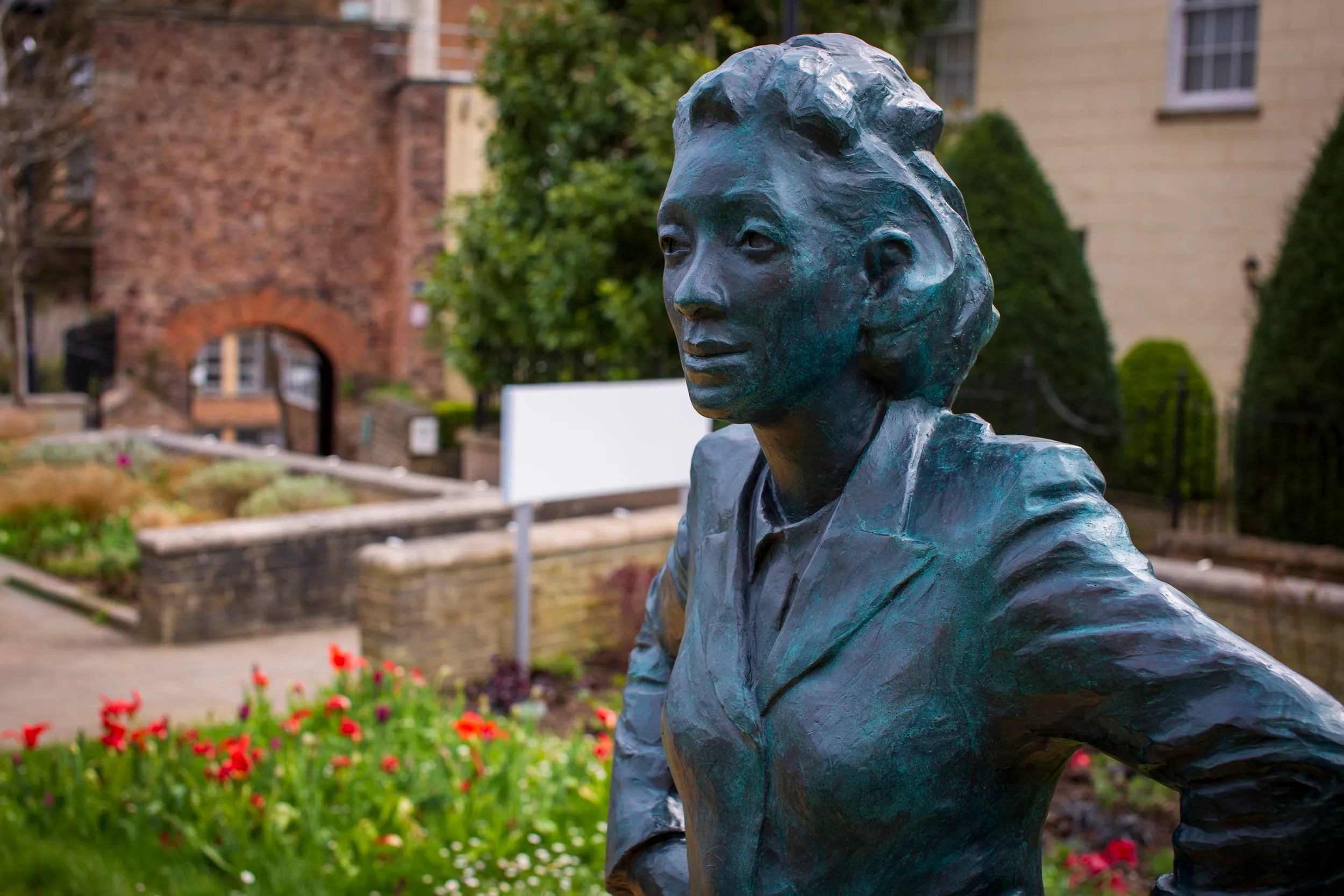 Close-up of the bronze statue of Henrietta Lacks, showing her face and shoulders