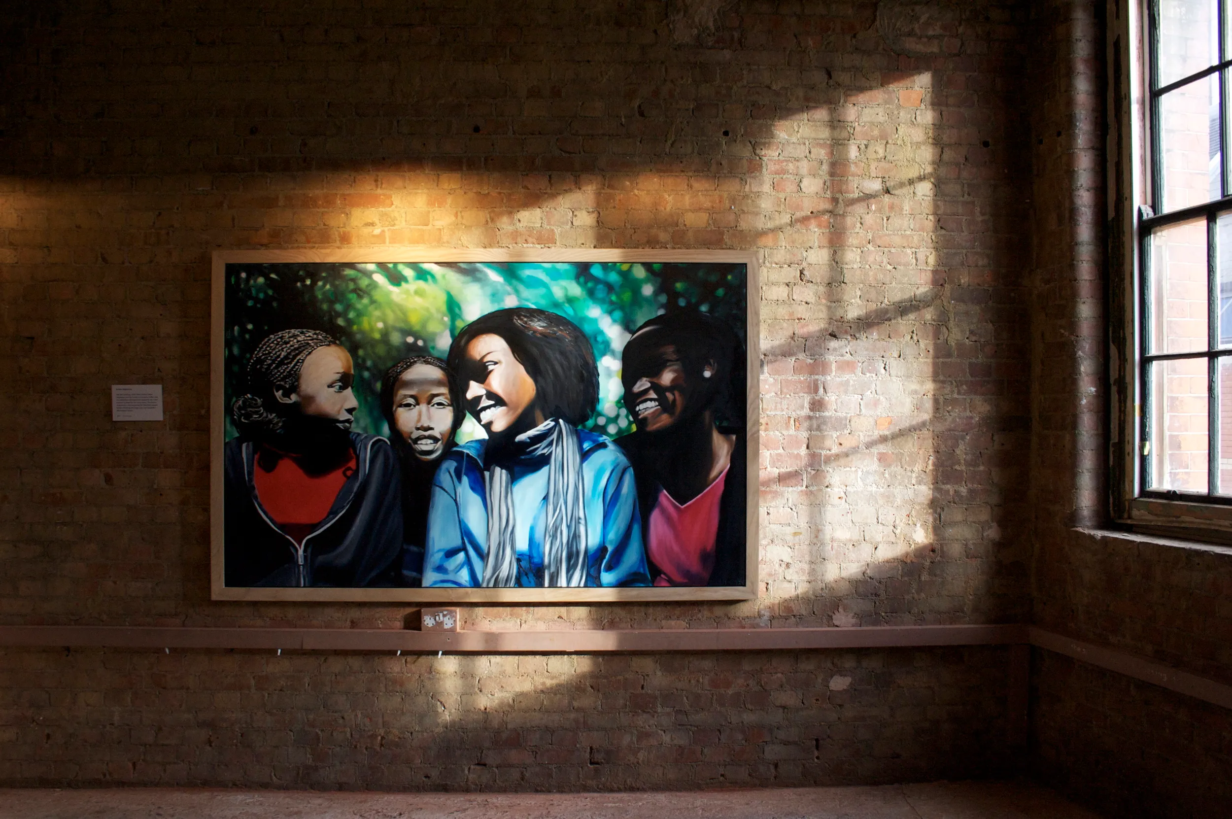 Painting of four young women laughing together outdoors against a backdrop of green foliage